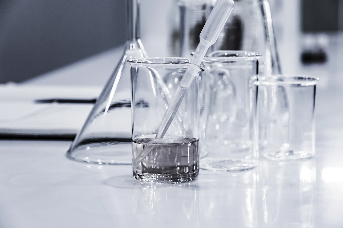 Scientific calculator and laboratory notebook showing peptide calculations